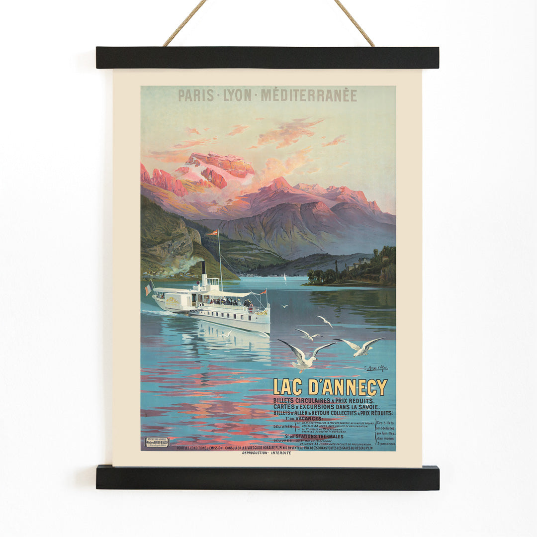 Poster of Le Lac d Annecy by Frederic Hugo d Alesi showing a scenic mountain lake with boat and seagulls at sunset, with wooden magnetic frame on white background