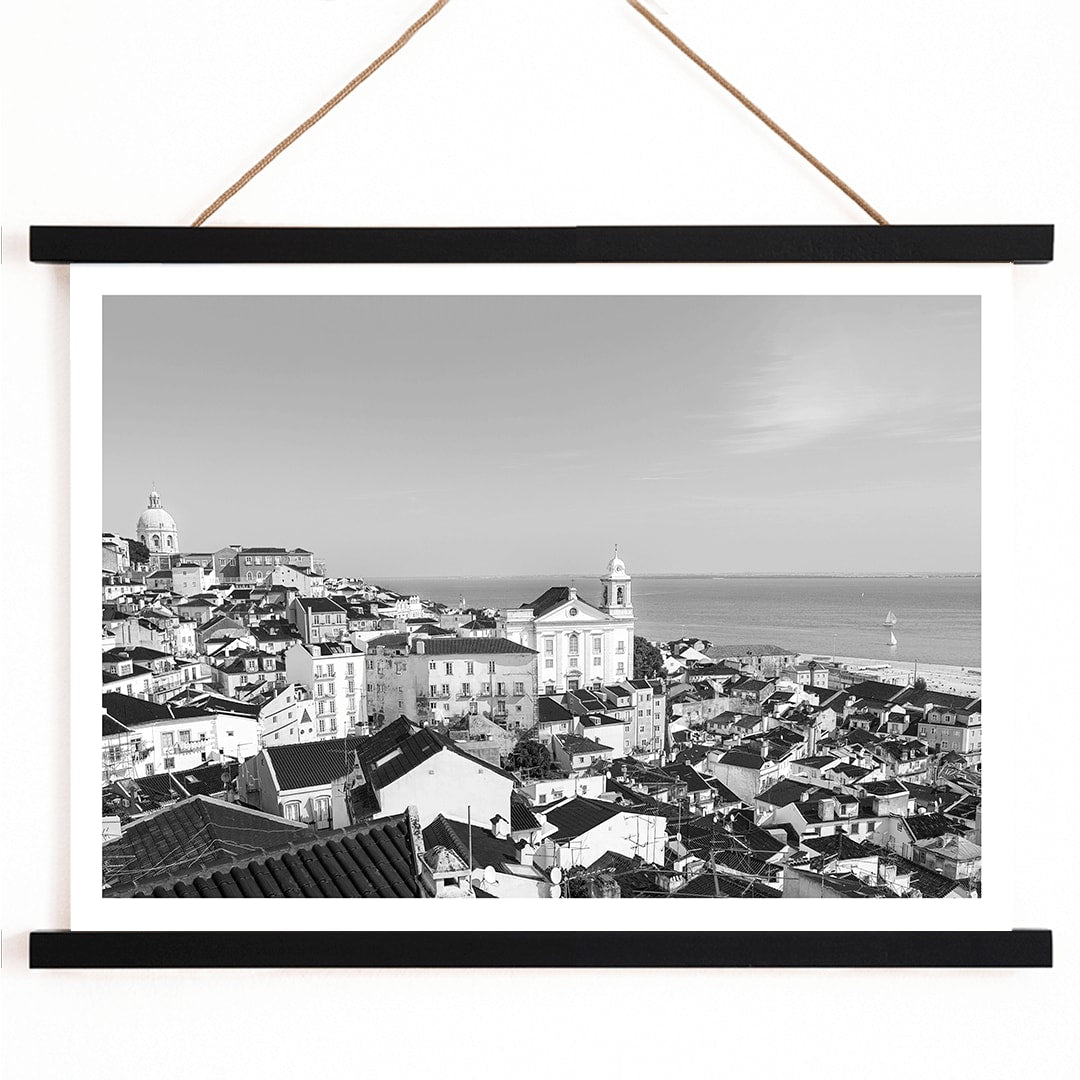 Black and white landscape poster of Alfama Lisbon Old City with traditional buildings and Tagus River by artist Alfama Lisbon, with wooden magnetic frame on white background