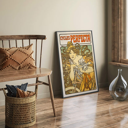 Art Nouveau poster of a woman with flowing hair riding a bicycle with decorative floral design by Alphonse Mucha for Cycles Perfecta, framed and displayed in home decor