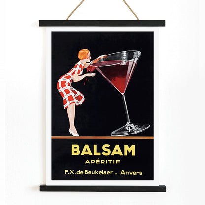Balsam Aperitif poster by Jean d Ylen showing a woman sipping from a giant red cocktail glass vibrant vintage art, with wooden magnetic frame on white background