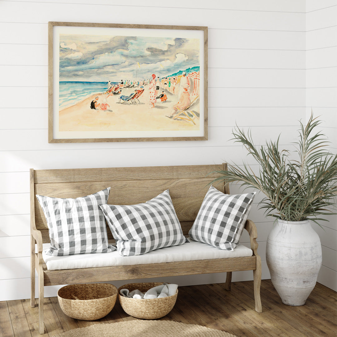 Colorful beach scene with people relaxing on deck chairs and under umbrellas at La plage de Deauville by Henri Lebasque, framed and displayed in home decor