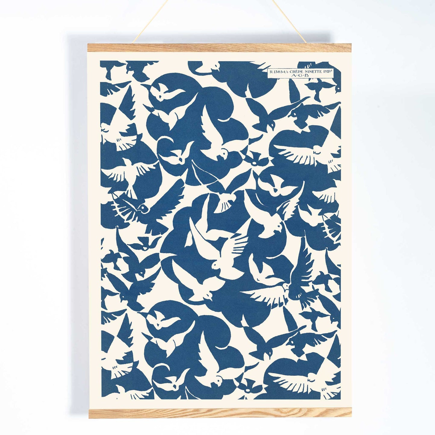Charles Goy Lesbesse crepe poster with stylized birds in bold blue and cream minimalist design, with wooden magnetic frame on white background