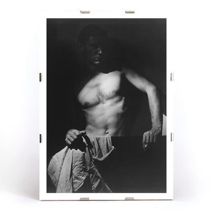 Shirtless man holding towel in dramatic lighting Max After Surfing by Olive Cotton wall art photography poster, framed and displayed in modern living room decor
