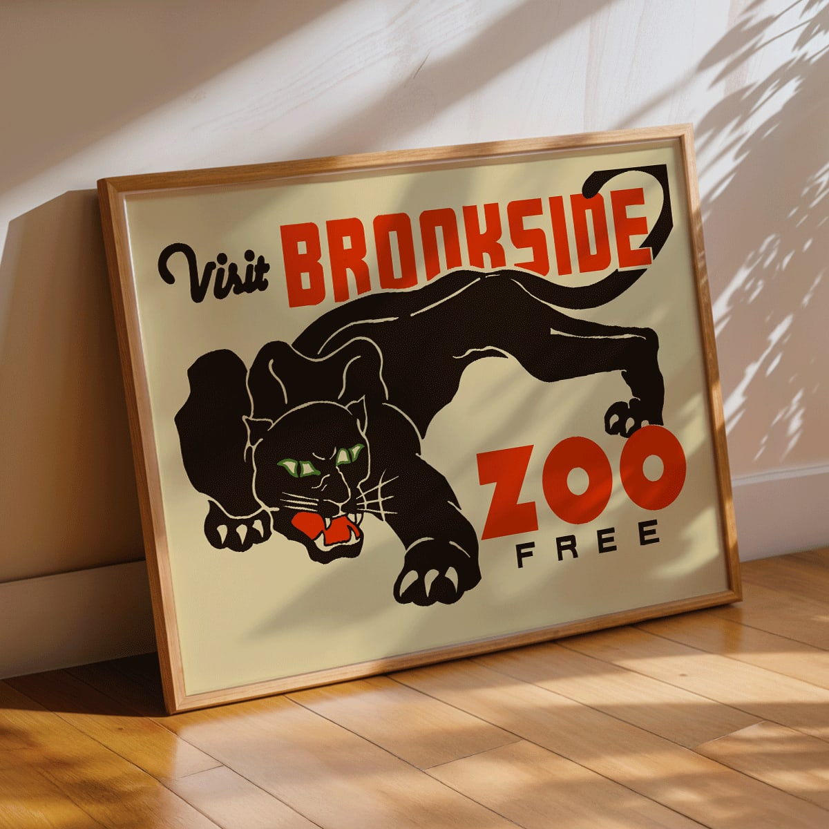 Visit Brookside Zoo poster featuring a black leopard illustration by Carken with the text Visit Brookside Zoo Free, framed and displayed in modern living room decor
