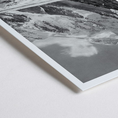 Closeup detail of Black and white photograph and poster of Broad Peak by Vittorio Sella showing snow covered mountains and mountaineers climbing amidst rocky terrain and glacier