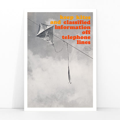 Black and white photo and poster of a kite tangled on a telephone line with bold warning text Keep kites and classified information off telephone lines, framed and displayed in modern living room decor