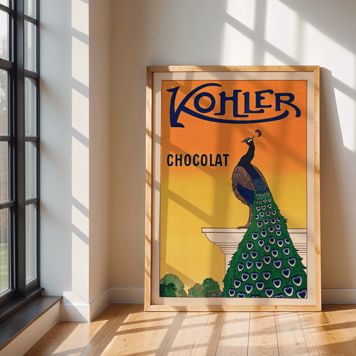 Kohler Chocolat art nouveau poster by F Champenois with vibrant peacock on pedestal against orange background, framed and displayed in modern living room decor