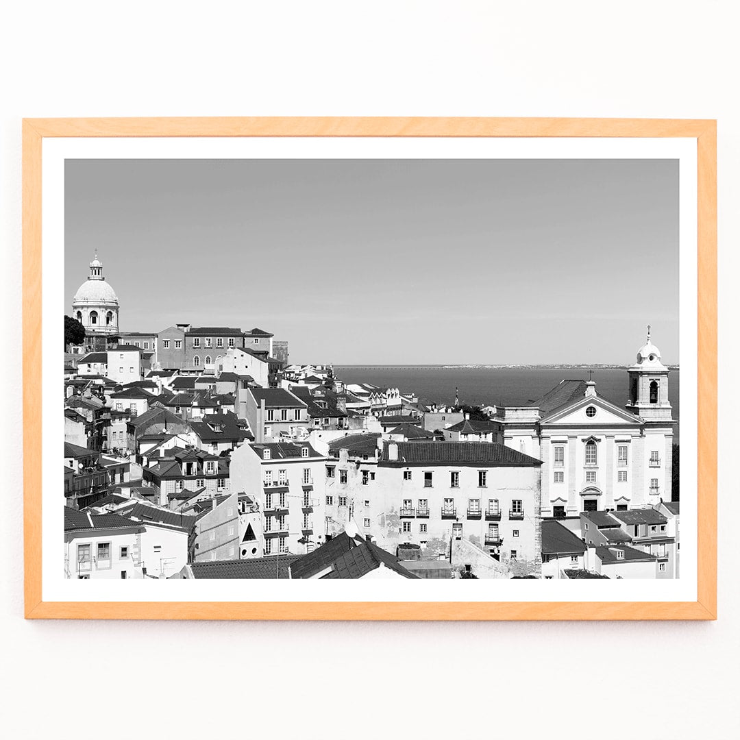 Black and white landscape of Lisbon Old City with historic architecture rooftops and distant sea view poster by Picture 2, framed and displayed in modern living room decor