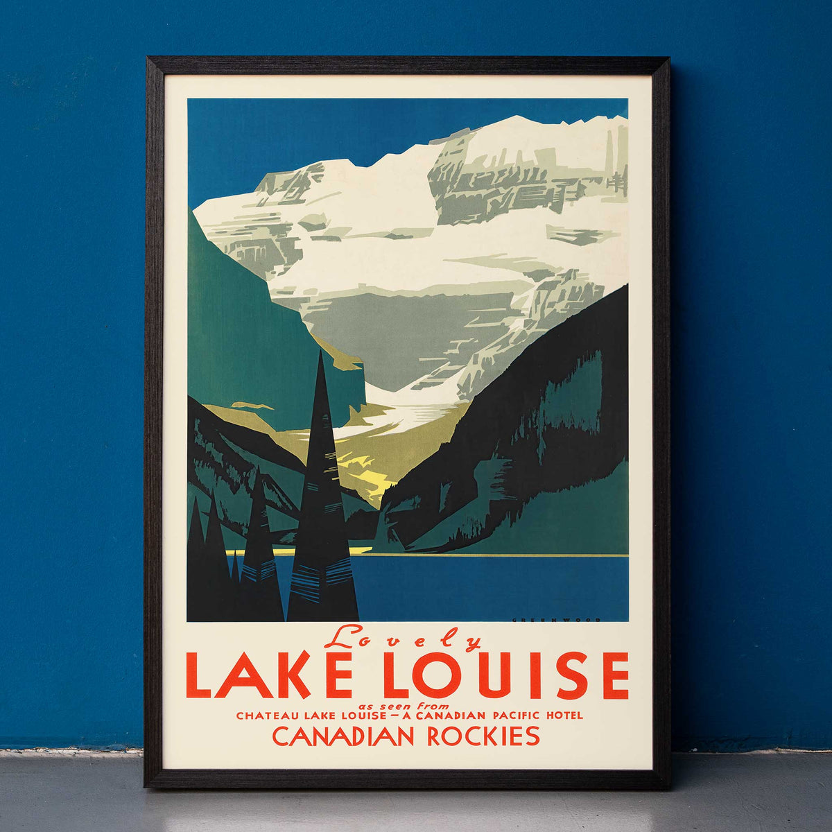 Lovely Lake Louise Canadian Pacific poster with snowy Canadian Rockies, pine trees and blue alpine lake in Canada, framed and displayed in home decor