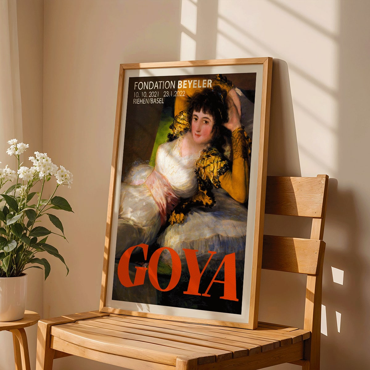 The Clothed Maja exhibition poster by Francisco Goya at Fondation Beyeler showing a reclining woman in a white and gold dress with yellow sleeves, framed and displayed in home decor
