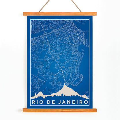 Minimalist blue and white Rio de Janeiro map poster by Moryarty featuring detailed street lines and city skyline silhouette, with wooden magnetic frame on white background