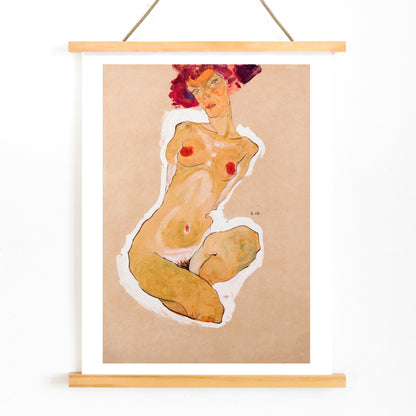 Colorful expressionist painting poster of a nude woman squatting titled Squatting Female Nude by Egon Schiele, with wooden magnetic frame on white background