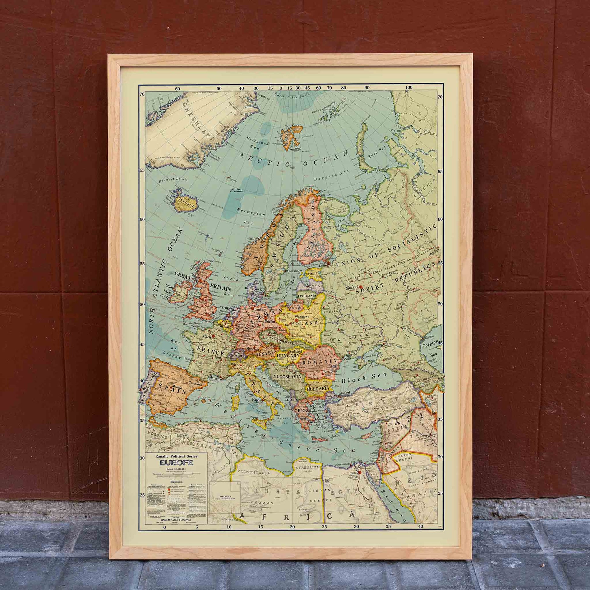 Rand McNally and Company Political Map of Europe poster with detailed continental map, colored borders, seas, and vintage cartographic typography, framed and displayed in home decor