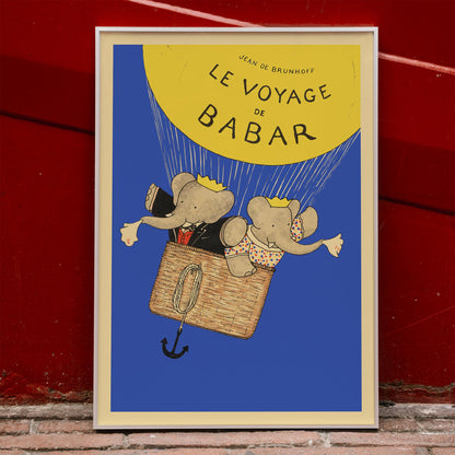 Le Voyage de Babar by Jean de Brunhoff illustration and poster featuring elephants in a hot air balloon with a yellow balloon on a blue background, framed and displayed in home decor