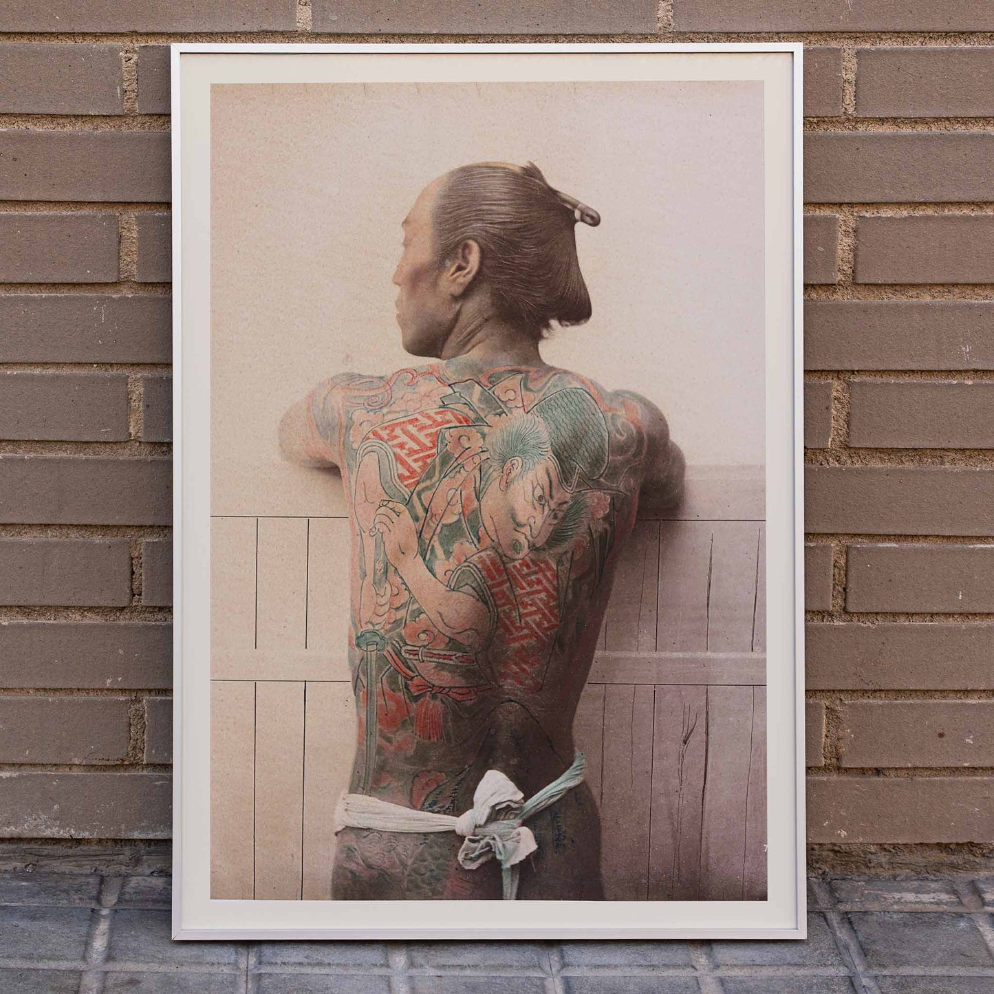 Japanese Tattoo artwork by Raimund von Stillfried featuring man with intricate traditional back tattoo, framed and displayed in home decor