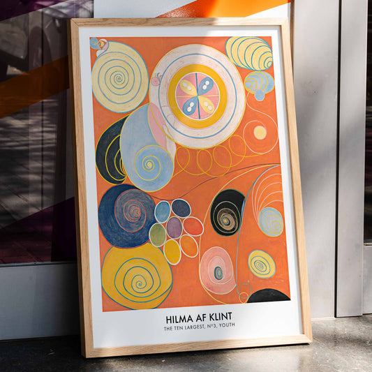 Abstract colorful spirals and organic shapes on vibrant orange background from The Ten Largest Youth by Hilma af Klint, framed and displayed in home decor