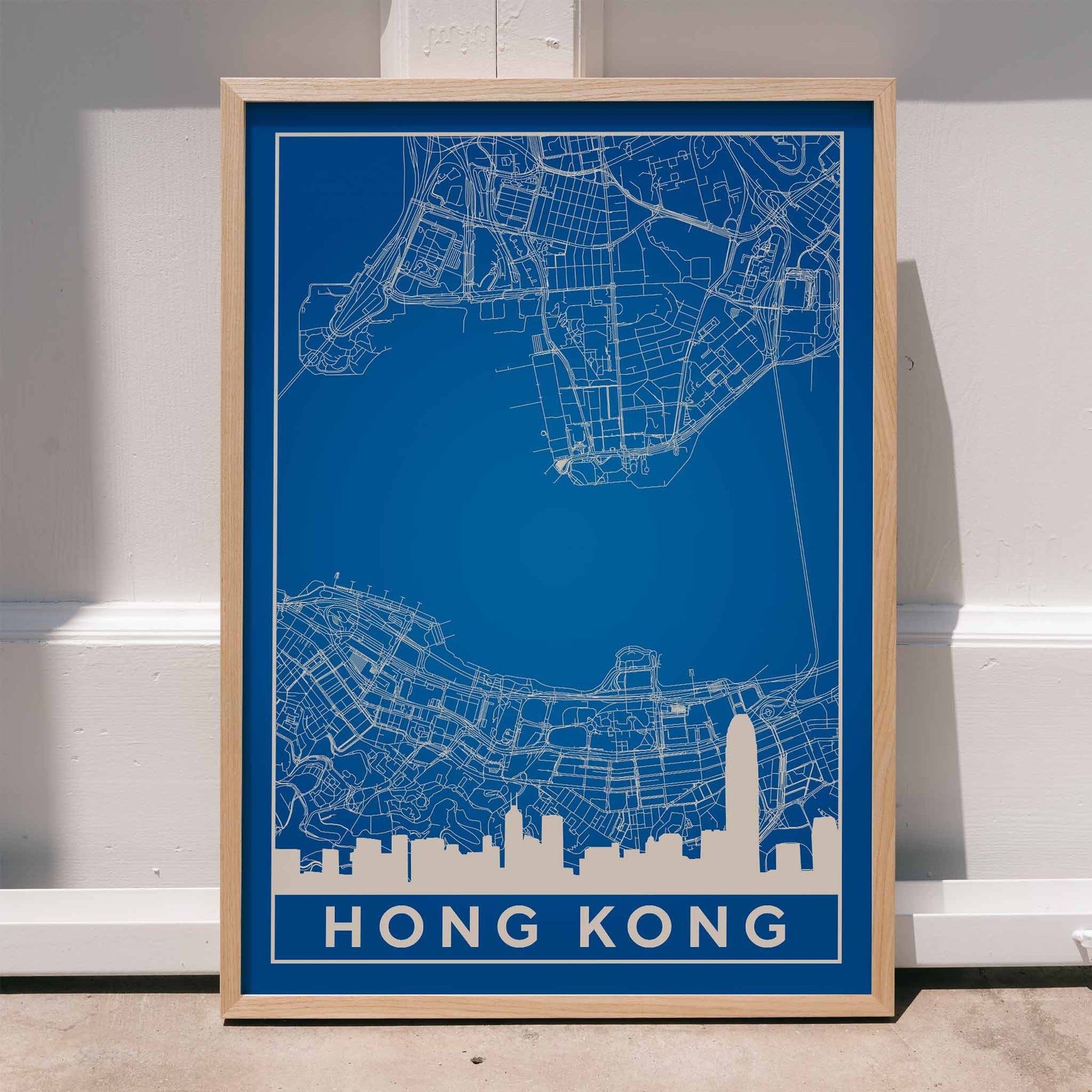 Hong Kong Minimalist Map by Artist Name blue urban blueprint wall art poster featuring city skyline and street layout, framed and displayed in home decor