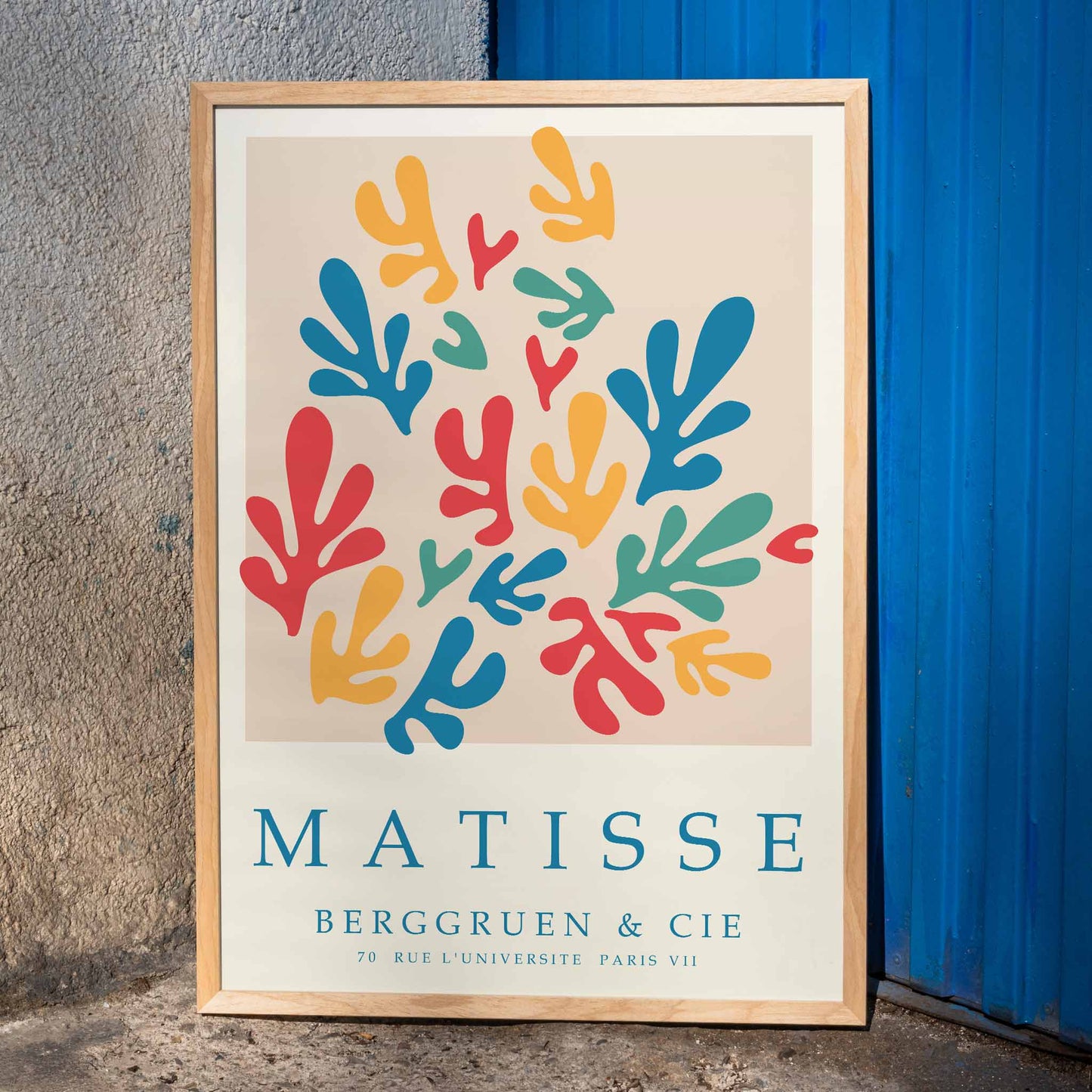Colorful abstract shapes inspired by Matisse in Papiers decoupes 2 poster with text Matisse Berggruen et Cie Paris, framed and displayed in home decor