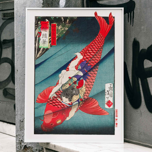 Young boy holding and wrestling a giant red koi fish in vibrant Japanese woodblock print Saito no Oniwakamaru by Tsukioka Yoshitoshi, framed and displayed in home decor