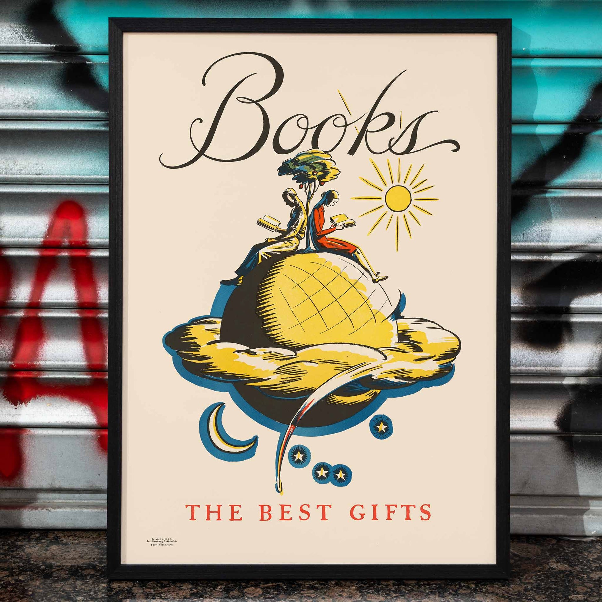 Books the Best Gifts by Edward Arthur Wilson poster with vibrant whimsical illustration of readers on a globe and celestial motifs, framed and displayed in home decor