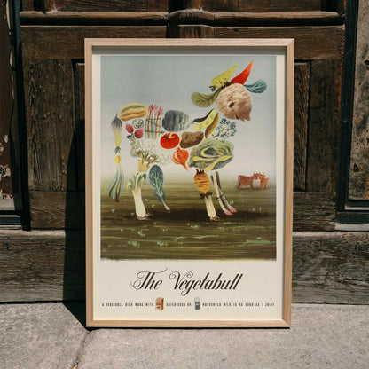 The Vegetabull by Lewitt-Him painting and poster showing a bull made of vegetables on grass background, framed and displayed in home decor