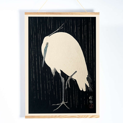 White egret standing in the rain art print poster with dark background by Ohara Koson, with wooden magnetic frame on white background