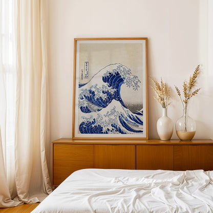 The Great Wave off Kanagawa by Katsushika Hokusai showing a dramatic large wave threatening small boats with Mount Fuji in the background, framed and displayed in home decor