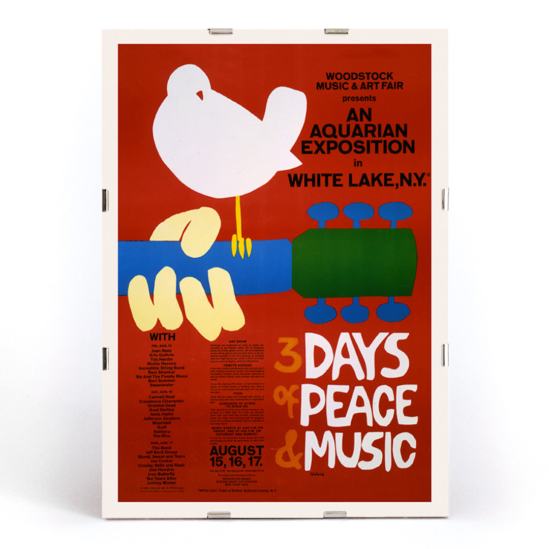 Woodstock poster with white dove on guitar promoting peace and music at An Aquarian Exposition in White Lake artist unknown, framed and displayed in modern living room decor