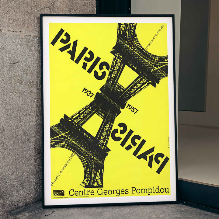 Roman Cieślewicz Paris-Paris 1937-1957 poster with yellow background black Eiffel Tower and mirrored typography, framed and displayed in modern living room decor